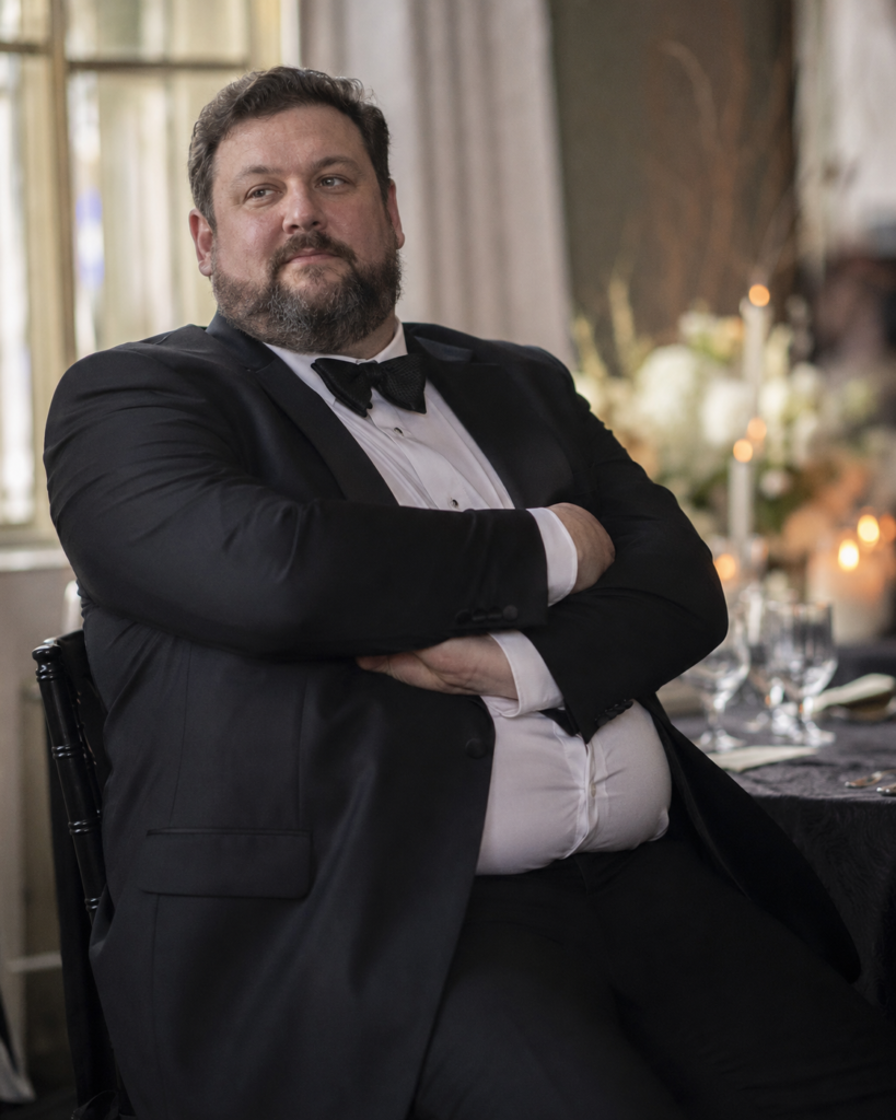 Black Tuxedo With a Fitted White Spread Collar Shirt and a Textured Black Tie