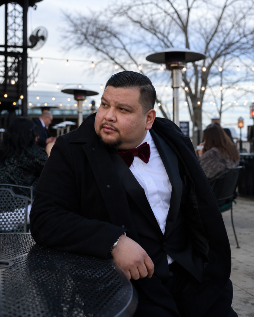 Black Wool Suit With a Burgundy Velvet Bow Tie and a Wool Overcoat
