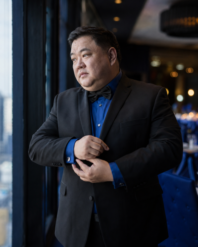 Black Tuxedo With a Deep Sapphire Blue Dress Shirt, Black Bow Tie, and Silver Cufflinks