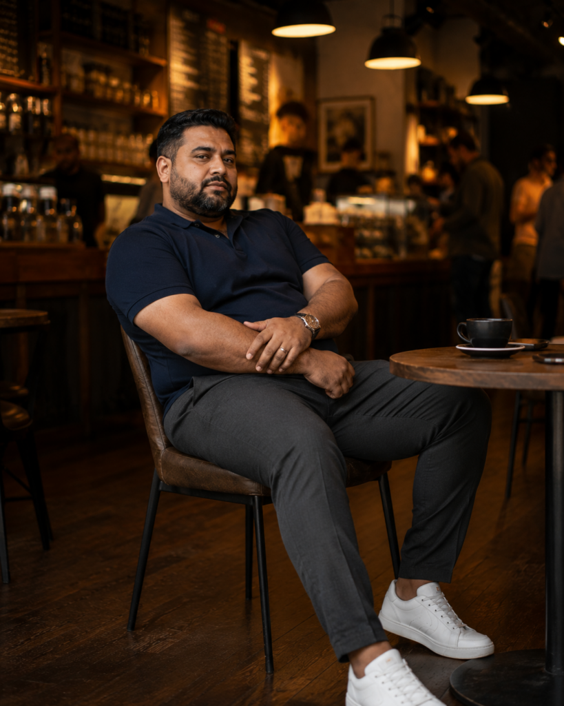 Charcoal Jogger-Style Dress Pants With a Tucked Navy Polo and Clean Leather Sneakers