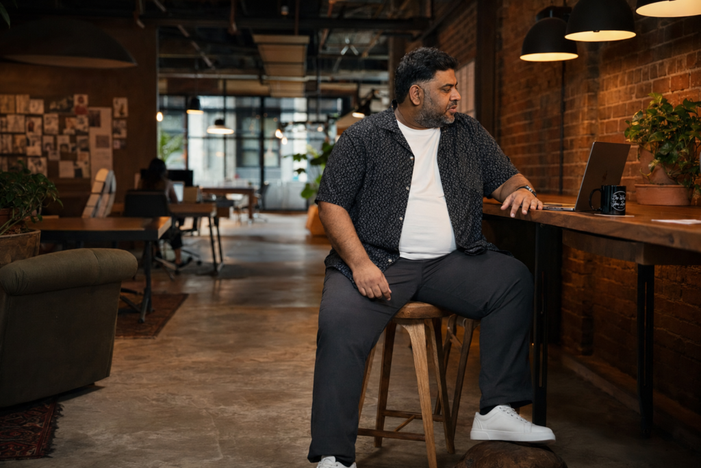 Dark Charcoal Relaxed Chinos With a Patterned Short-Sleeve Camp Shirt and White Trainers