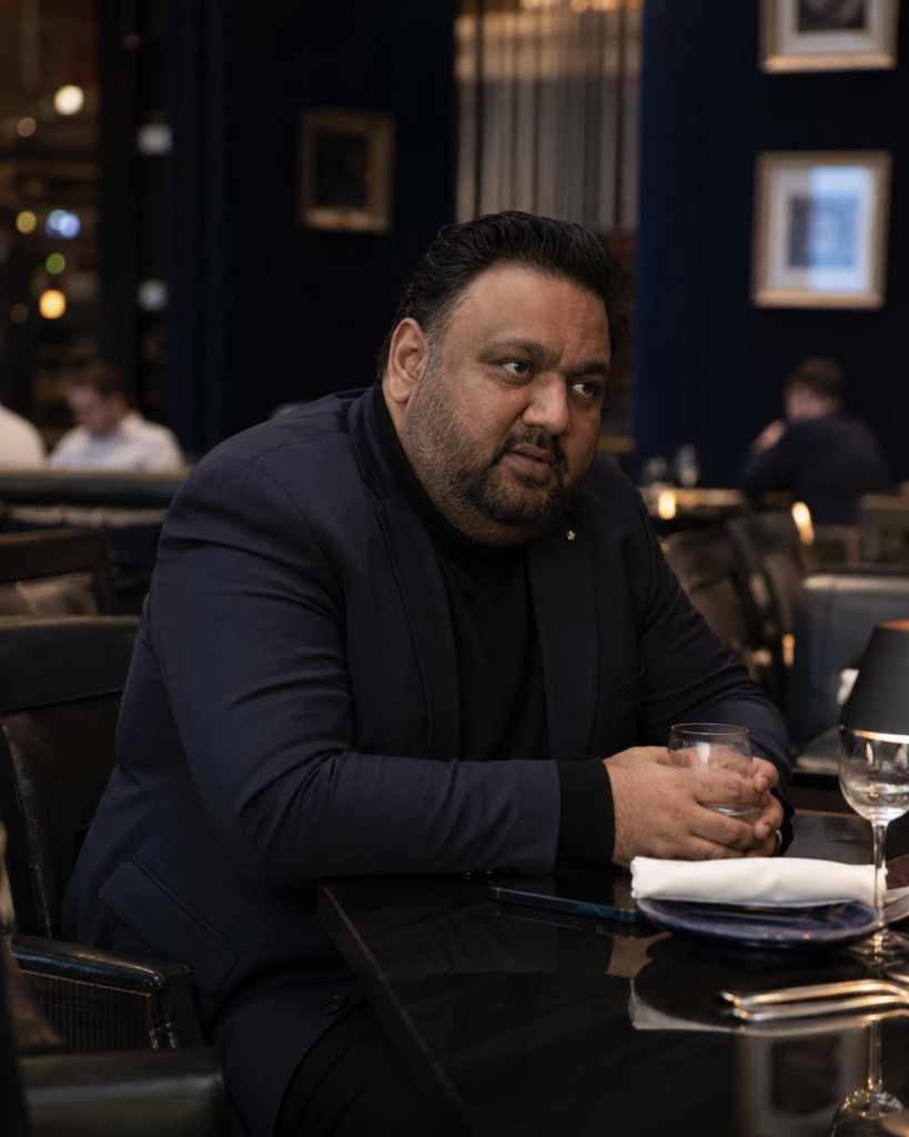 Navy Slim Blazer Over a Black Turtleneck With Tailored Black Trousers