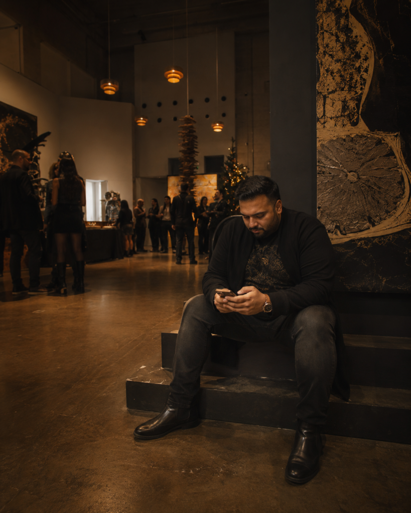The Black Longline Cardigan Over a Printed Tee and Dark Slim Jeans With Chelsea Boots